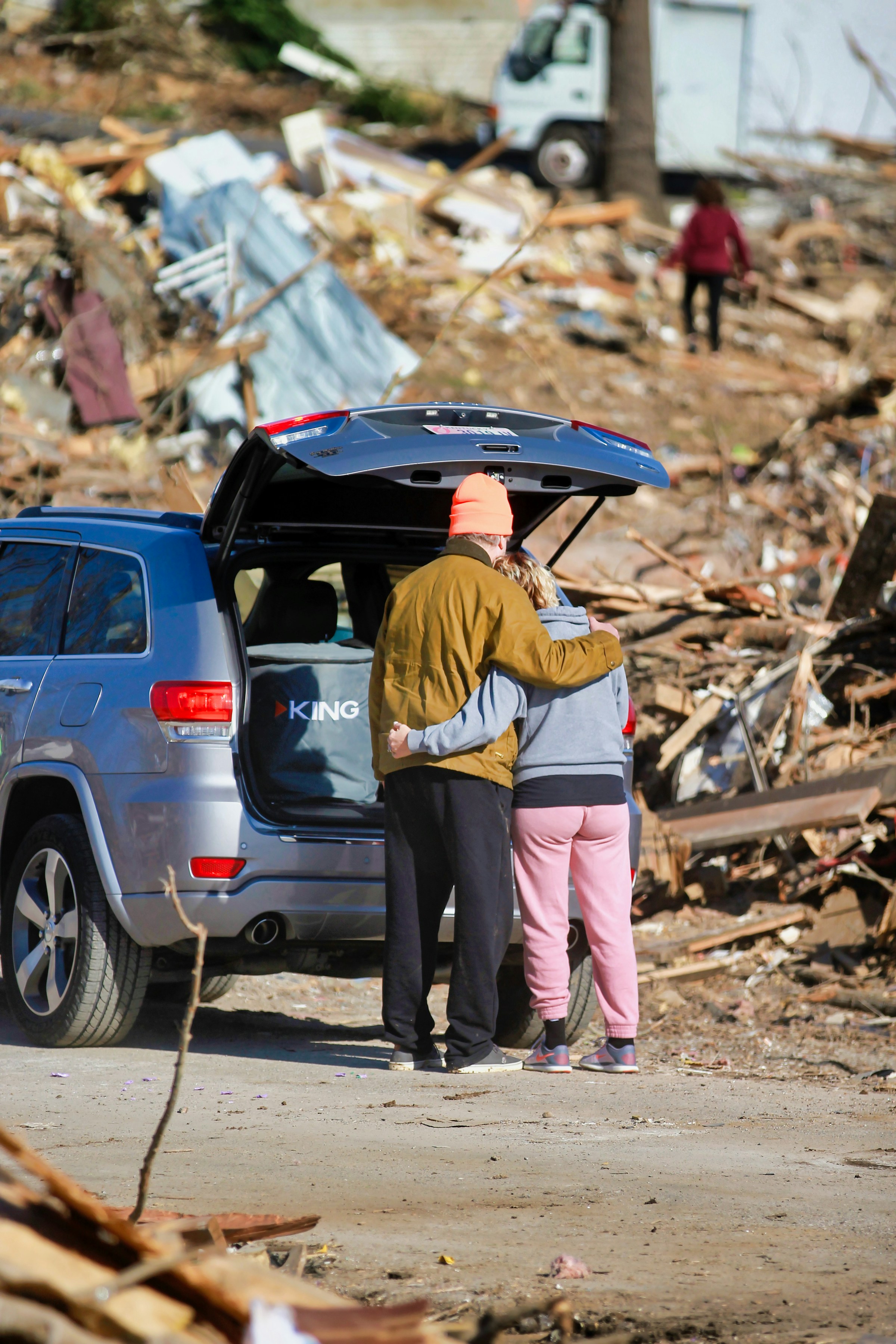 A couple supporting each other after storm damage to their home